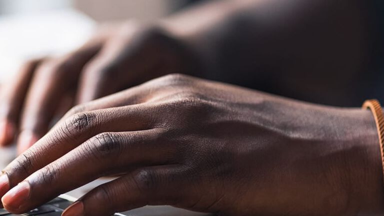 hands typing on a computer hands typing on a computer