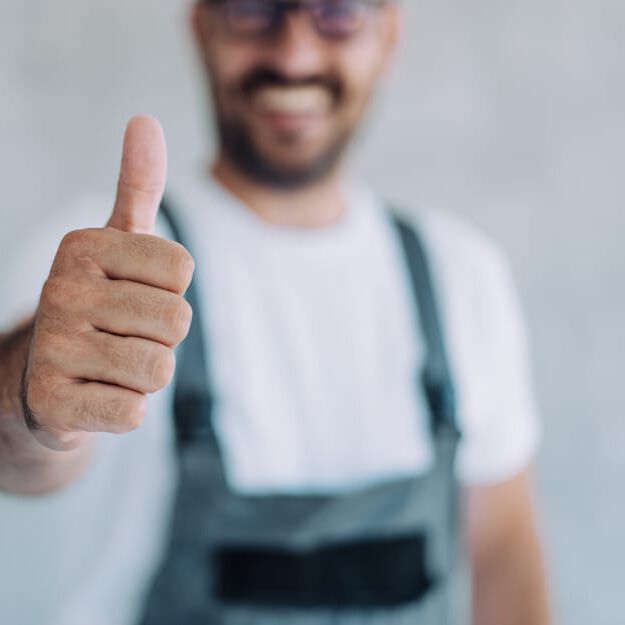 professional contractor smiling and giving thumbs-up professional contractor smiling and giving thumbs-up