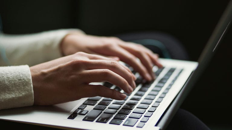 Person typing on a laptop Person typing on a laptop